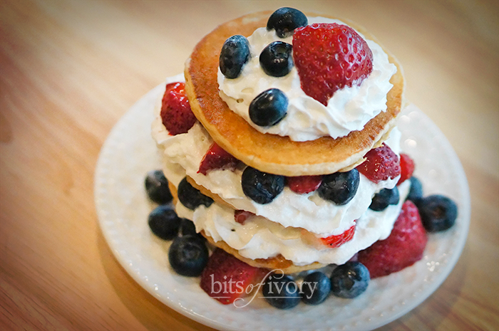 Whole wheat pancakes with whipped cream and berries