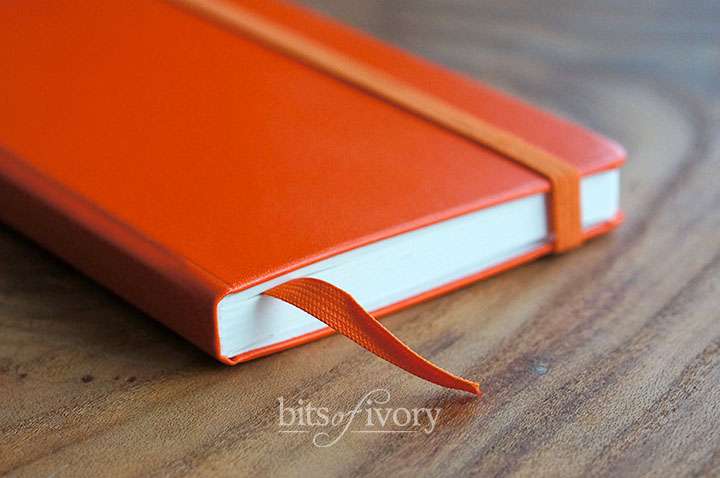 Orance notebook with bookmark
